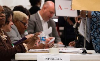 A volunteer checks off voters as they arrive at the Beulah Baptist Church polling station in Montgomery, Alabama, on Dec. 12, 2017.