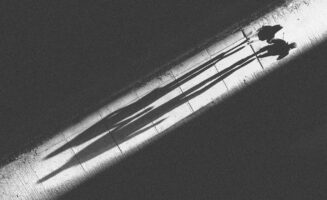 Two people walk on glowing footpath