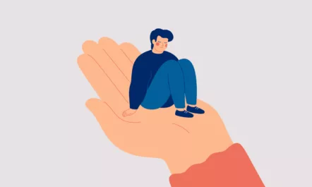 Sad man sits on the big human hand and needs care and support