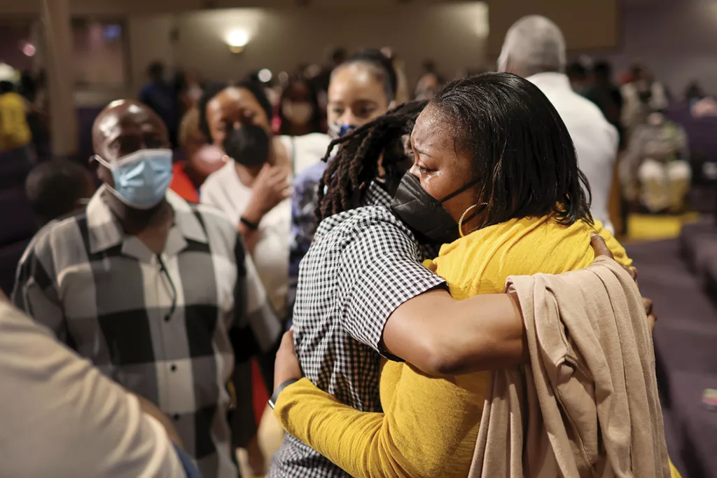 A day after the hate crime and mass shooting at Tops Market, Latisha Rogers is comforted by the community and support of True Bethel Baptist Church in Buffalo, New York, on Sunday, May 15, 2022.