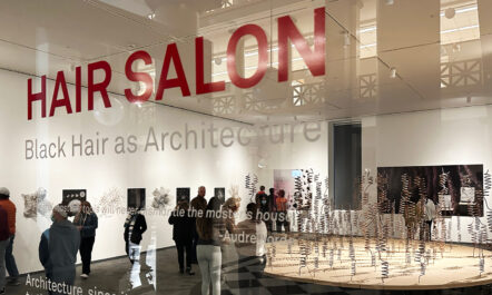 Photo of glass door for the "Hair Salon: Black Hair as Architecture" exhibit