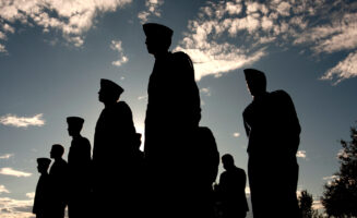 Silhouettes of soldiers with the skyline in the background