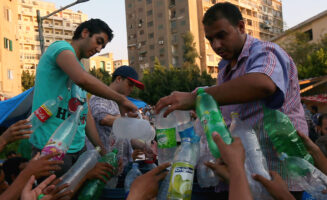 A group of people recycling plastic bottles