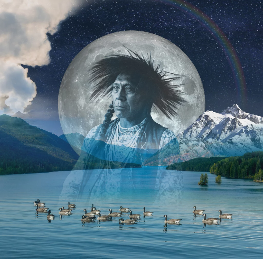 A photo illustration by Mer Young depicts a mountain lake with geese floating in the water, overlaid with a greyscale photograph of a tribal elder, wearing braids and a headpiece. A full moon with rainbow glow is visible in the background.