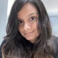 Grace Hussain is a brown-skinned woman with long black hair