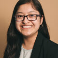 Esperanza Cuautle is a Mexican woman with long black hair and glasses who is smiling at the camera