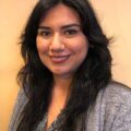 Vanessa Godinez is a woman with long hair and a gray blazer on