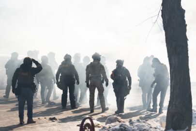 ICE and Border Patrol agents on Nicollet Avenue facing tear gas