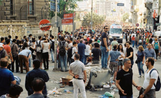 A dense crowd flowing into Taksim Square parts to let an ambulance through on June 1