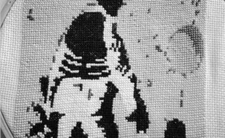 Embroidered image of a soldier and child by Betsy Greer.