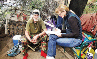 Kerry Morrison interviews homeless veteran John Watkins in the Hollywood Hills. Hollywood was one of the first communities to join the 100