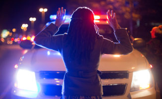 "Hands Up Don't Shoot" with cop car by Joshua Sinn