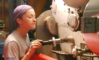 Mallory White of Equal Exchange checks coffee roaster