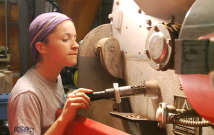 Mallory White of Equal Exchange checks coffee roaster