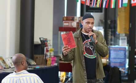 Khalid giving a lecture on the origins of the stereotypes of Black inferiority using Chase Carroll's The Negro a Beast or in the Image of God. (Portland Community College