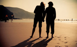 people on beach by Kirsty Andrews