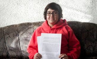 Noam Gur poses with her letter