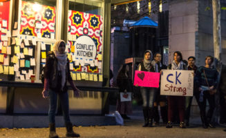Woman speaking at Conflict Kitchen by Heather Kresge
