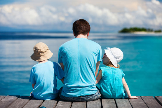 Dad and Kids at Beach photo by Shutterstock